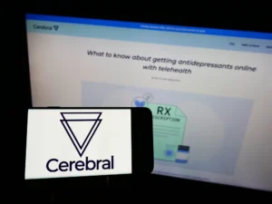 A_smartphone_and_a_computer_monitor_show_the_Cerebral_logo_representing_the_U.S._governments_lawsuit_against_the_company._