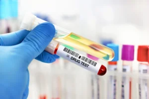 A_Gloved_Hand_Holds_Two_Vials_One_of_Which_Reads_Drug_Tests_Representing_Medical_Fraud_Charges_Against_Dr._Michael_Dole_The_Daily_Muck