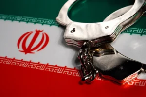 A_Pair_of_Handcuffs_on_an_Iranian_Flag_Represents_the_Arrest_of_Gholam_Reza_Goodarzi_a_Dual_IranianAmerican_Citizen_Who_Stands_Accused_of_Illegally_Transferring_Drone_Technology_to_Iran_The_Daily_Muck