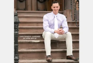 A_Promotional_Photo_Shows_Christopher_Viagrande_Sitting_in_Front_of_His_Practice_in_Latham_NY_The_Daily_Muck