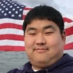 Baltimore_TeacherSexual_Predator_Christopher_Bendann_Smiles_with_an_American_Flag_in_the_Background_on_his_LinkedIn_Photo_The_Daily_muck
