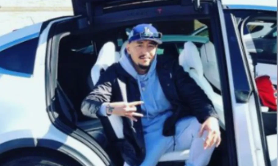 In_a_photo_provided_by_the_prosecution_Daekun_Cho_sits_in_the_back_of_a_luxury_vehicle_and_flashes_gang_signs