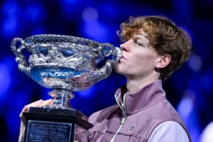 Jannik_Sinner_kisses_a_trophy_he_won_in_the_Australian_Open._He_claims_to_have_tested_positive_for_anabolic_steroids_due_to_the_fingers_of_his_massage_therapist_The_Daily_Muck