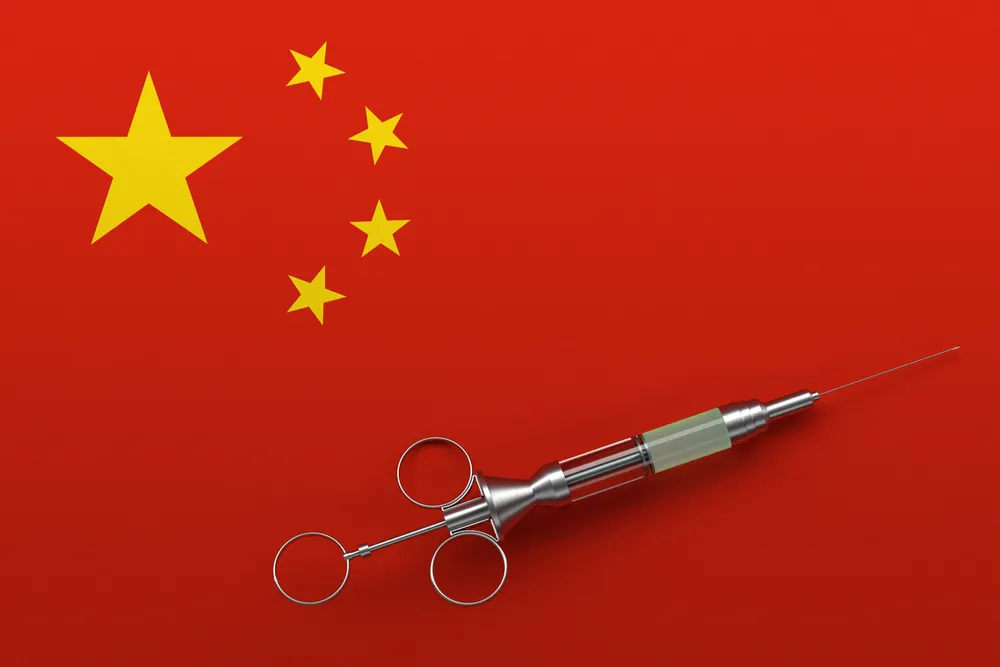 A_Drug_Injection_Sits_Atop_a_Chinese_Flag_Representing_Doping_Allegations_Against_23_Chinese_Swimmers_that_Have_not_Been_Fully_Resolved_The_Daily_Muck