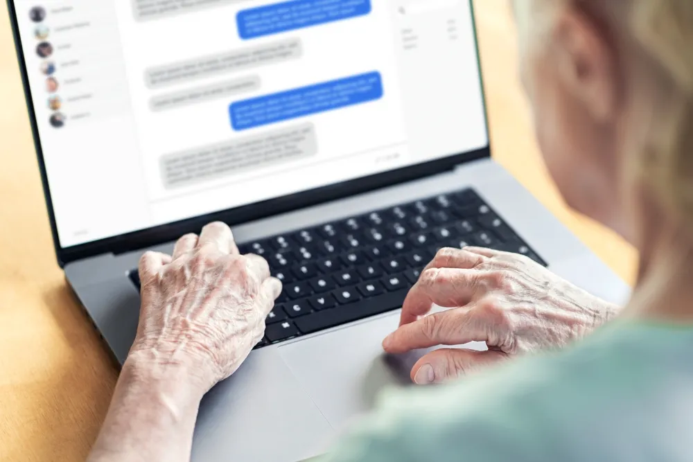 An Elderly Woman Uses a Messaging App on Her Laptop Representing at Least 12 Women That Ogheneofejiro Godswill Uzokpa Victimized with Romance Scams - The Daily Muck