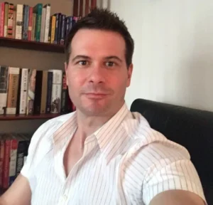 Another photo shared by the FBI shows Raymond taking a selfie in front of a bookcase, ostensibly in his U.S. embassy-leased housing