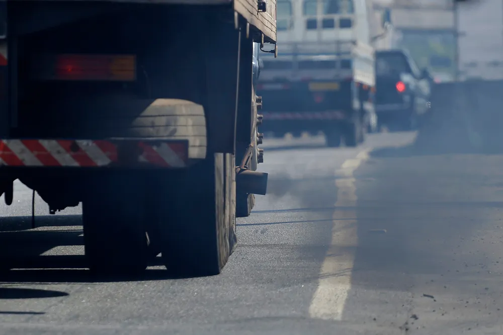 A Truck Spews Black Toxic Smoke From Its Exhaust Pipe Representing People Like Isaac Allen That Sell Emissions Defeat Devices That Harm The Environment and Circumvent the Law