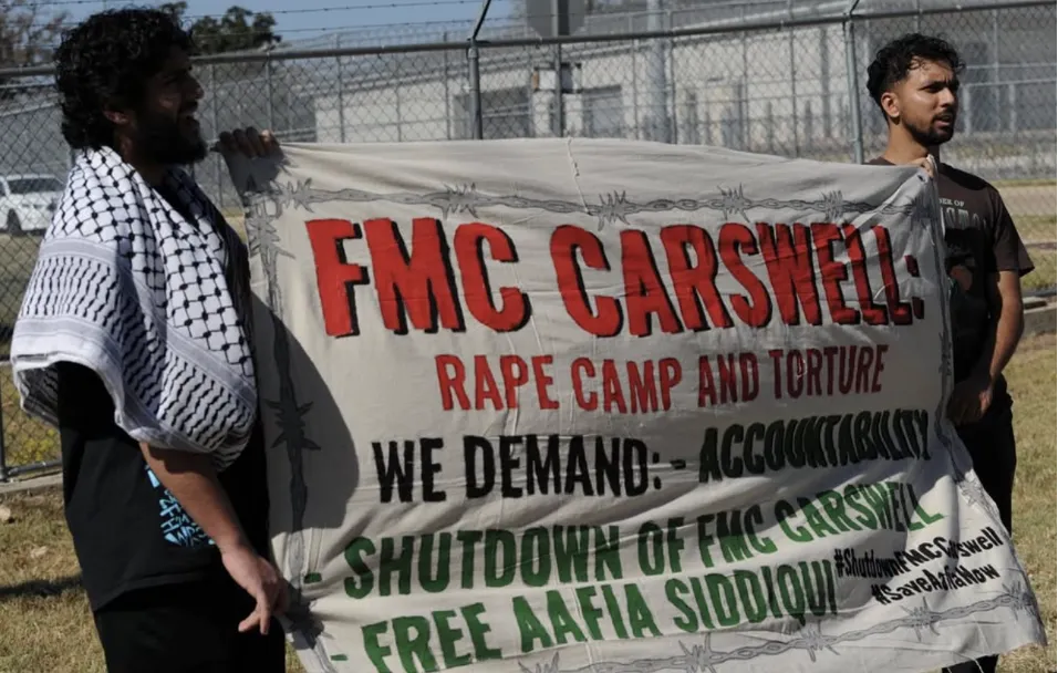 Demonstrators_hold_a_banner_demanding_the_closure_of_FMC_Carswell_on_Oct26