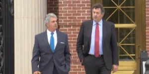 Jeffrey Allen Benjamin Walking Out of a Courthouse With His Attorney Has Been Sentenced to One Year and One Day in Prison For His Rule in a Nuclear Power Plant Scheme