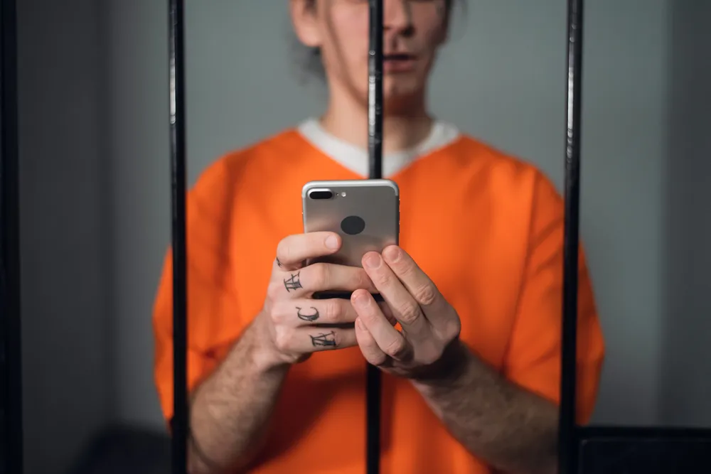 A_Dangerous_Criminal_in_Prison_Uses_a_Cell_Phone_to_Commit_Fraud_and_Other_Crimes_a_Growing_Problem