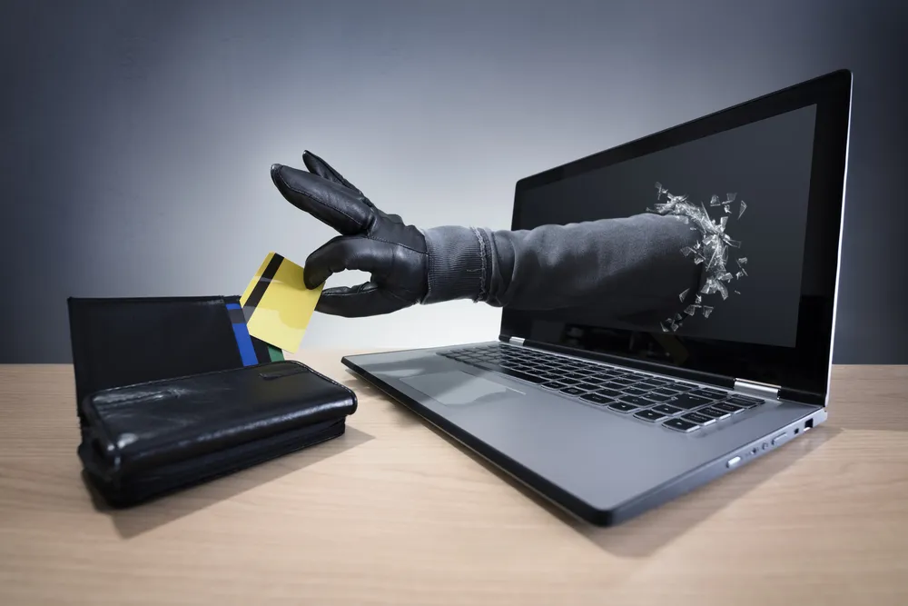 A_Gloved_Hand_Reaches_Through_a_Computer_Screen_Stealing_a_Document_from_a_Wallet_Representing_an_Illegal_Immigration_Case_Bolstered_by_Identity_Theft